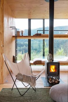 a living room filled with furniture and a fire place next to a window covered in wood