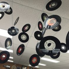 many records are hanging from the ceiling in an office building with white walls and ceilings