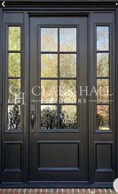 a black double door with two sidelights and glass panes on the front entrance