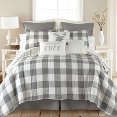 the comforter is made up in plaid patterns and has two pillows on top of it