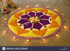 a circular flower arrangement with candles on the ground