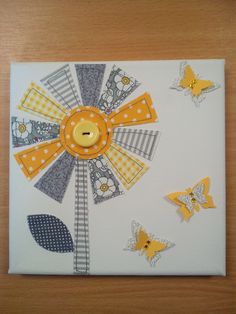 an art piece with yellow buttons and butterflies on it