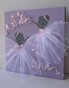 a purple canvas with two ballerinas on it