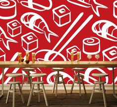 a dining room table with chairs and a wall mural behind it that has different types of food on it