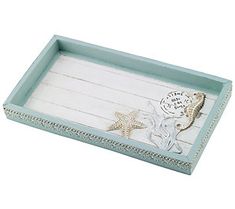 a wooden tray with seahorses and starfish on the bottom, painted in blue