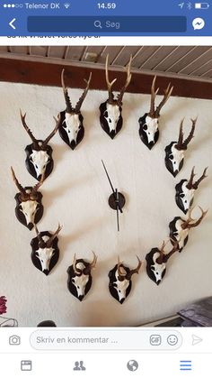 a clock with deer heads mounted to it's face and the numbers six on each side