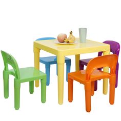 three children's plastic chairs and a table with fruit on it, against a white background