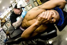 a man laying on top of a chair in a barber shop