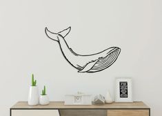 a wall clock with a drawing of a whale on it