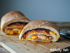 two sandwiches cut in half on a cutting board