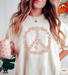 "Hippie Peace Sign Shirt, Boho Peace Oversized Tee, Floral Peace Symbol, Wildflowers T-Shirt, Peace Symbol Shirt, Graphic Tees For Women Our shirts are unisex sizing and they are made with the highest quality materials and are super soft and cozy! This style is UNISEX Garment-Dyed, RELAXED FIT, Comfort Colors T-shirt. If you'd like an oversized look, we suggest size up 1-2 sizes from your normal size! 👉FABRICATION * 6.1 oz., 100% ringspun cotton * Medium fabric * The soft-washed, garment-dyed f Peace Sign Clothes, Peace Sign Shirts, Graphic Tees For Women, Hippie Peace, Selling Clothes, Tees For Women, Oversized Tee, Peace Sign, Peace Symbol