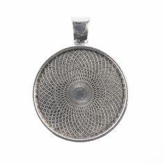 a silver pendant with a circular design on it