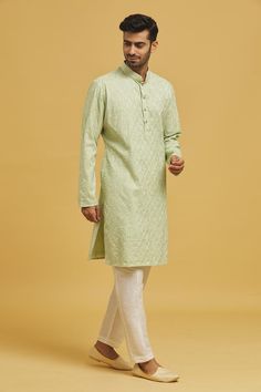 Pista green cotton silk based kurta with chikankari embroidery. Comes with off white dupion silk Mexican pant.
Components: 2
Pattern: Embroidered
Type Of Work: Chikankari
Neckline: Mandarin
Sleeve Type: Full
Fabric: Cotton Silk, Dupion Silk, Lining: Cotton
Color: Green
Other Details: 
Side pocketed pant
Model is wearing size M/40
Closure: Kurta: Front button placket
Occasion: Mehendi and Puja - Aza Fashions Transitional Green Cotton Churidar, Transitional Green Cotton Sherwani, Green Cotton Sherwani With Straight Kurta, Pista Green Cotton Churidar With Chikankari Embroidery, Green Cotton Sherwani With Zari Work, Green Cotton Kurta For Transitional Season, Transitional Green Cotton Kurta, Transitional Green Cotton Traditional Wear, Pista Green Chikankari Embroidery Straight Kurta