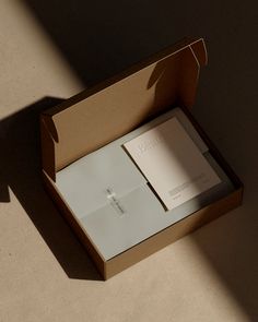 an open box with papers inside on the floor