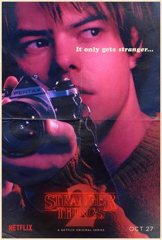 a movie poster with a young man holding a camera