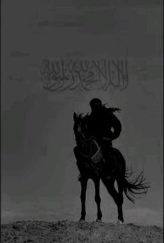 a black and white photo of a man on a horse with the word written in arabic