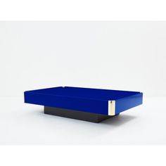 a blue and black coffee table sitting on top of a white floor