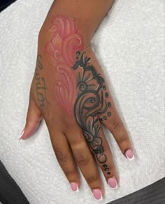 a woman's hand with tattoos on it