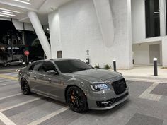 a silver car parked in front of a building