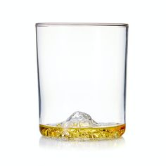 a glass filled with liquid sitting on top of a table