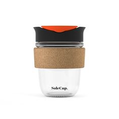 a glass cup with a cork lid and an orange cap on the top, sitting against a white background