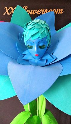 a paper flower with a blue face on it