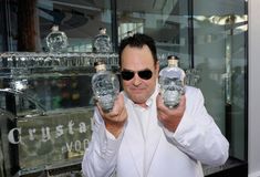 a man holding two glass bottles with skulls on them