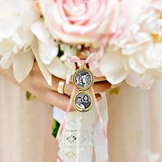 the bride's bouquet is adorned with her wedding rings and two photo medallions