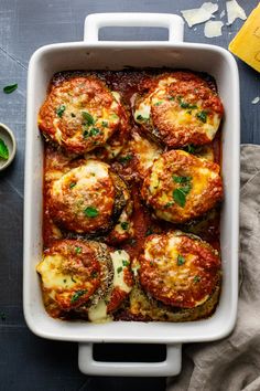 a casserole dish filled with eggplant parmesan cheese and spinach