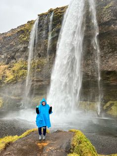 a person standing in front of a waterfall