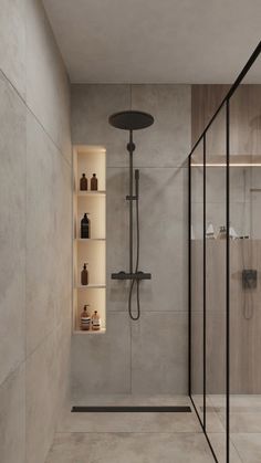 a walk in shower sitting next to a glass wall with shelves on each side and an illuminated shelf above it