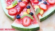 slices of watermelon, kiwi, strawberries and other fruit on a plate