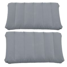 two gray pillows sitting next to each other