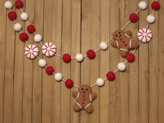 a wooden table topped with christmas decorations and gingerbreads on it's string