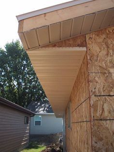 the side of a house that is covered in wood and has siding on it's sides