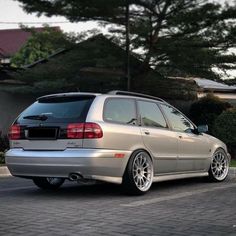 a silver car parked in front of a house