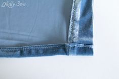 the bottom half of a pair of blue jeans with white stitching on them, folded up