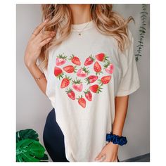 Strawberry Heart Distressed Graphic Tee. Choose between 4 color options. PRODUCT DESCRIPTION +Comfort Colors 1717 Unisex Crew Neck Tee. Medium Fabric 6.1 oz + Relaxed fit, size up for oversized tee. Want even bigger, size up 2 sizes for dress look. Check out size chart for measurements. + Soft Washed Garment Dyed Fabric. Dyed shirts can vary in color. +High Quality 100% Ring Spun Cotton + Double needle stitching for long lasting wear.  SHIPPING & TURNAROUND TIME + Made to order. Processing and printing time is generally 5-7 business days. Casual Heart Print T-shirt For Spring, Relaxed Fit Heart Print T-shirt For Summer, Casual Short Sleeve T-shirt With Heart Print, Summer Graphic Tee With Heart Print, Casual Heart Print T-shirt With Relaxed Fit, Summer Heart Print Short Sleeve T-shirt, Casual Heart Print T-shirt For Summer, Summer Cotton T-shirt With Heart Print, Relaxed Fit T-shirt With Heart Print And Short Sleeves