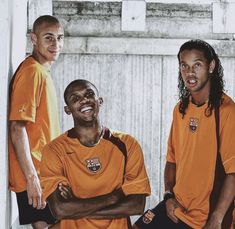 three soccer players are posing for a photo