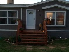 a small house with steps leading up to the front door