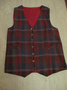 Classic handmade men's waistcoat, lightweight wool fabric with silver coloured buttons and little belt at back. Nice combination of blue, green, yellow & burgundy tones in this tartan. Two front pockets, pointed front & back and it is fully lined in contrast dark red satin.  I have hand washed it as wool and it came up lovely. Very good condition. Photographed with skirt & blouse to show proportions for women. Actual measurements : Chest 44 inches, shoulder to shoulder 15 inches, armhole depth a Fitted Plaid Vest For Winter, Fitted Plaid Cotton Vest, Tartan Men, Mens Waistcoat, Men's Waistcoat, Skirt Blouse, Mens Vests, Skirt And Blouse, Vest Outfits