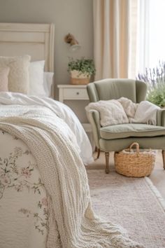 a white bed sitting next to a green chair in a bedroom on top of a rug