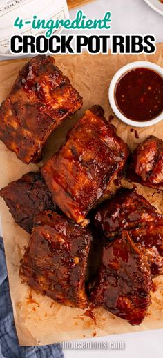 four ingredient crock pot ribs on a cutting board with dipping sauce in the background