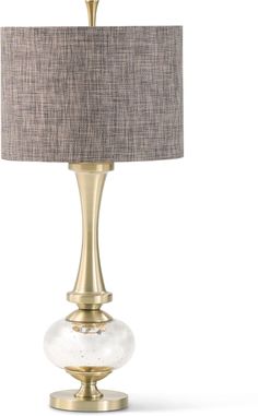 a lamp that is sitting on top of a white surface with a gold base and fabric shade