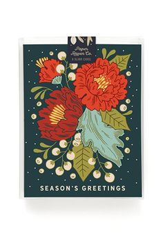 a greeting card with red flowers and green leaves on the front, says season's greetings