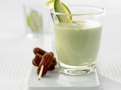 a glass filled with cucumber and some nuts