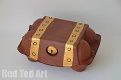 a cake shaped like a pirate's chest with gold trimmings on it