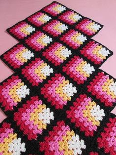 crocheted placemats are arranged on a pink surface