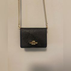 Please Read: Brand New Coach Wallet (Black) On A Gold Chain. You Will Receive The One That Is Brand New And Wrapped Up! The One Shown Is The Exact Same Thing But My Personal One That I Have Been Using! (I Had Ordered Two, One For Someone Else But I Did Not Give It To Them) Perfect For A Night Out Or Traveling With Small Baggage. Hard At Least 4 Cards, A Small Chapstick Or Lipstick, And Some Money! Formal Rectangular Coach Coin Purse, Coach Formal Crossbody Wallet On Chain, Coach Leather Wallet On Chain With Chain Strap, Coach Rectangular Wallet On Chain With Strap, Formal Rectangular Wallet With Chain, Formal Rectangular Wallets With Chain, Classic Black Wallet On Chain, Formal Black Coach Wallet On Chain, Black Rectangular Wallet With Chain Strap