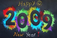 a sign that says happy new year 2009 written in colorful paint on a black background